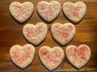 Sugar Cookies cut in shape of hearts, decorated with colorful sprinkles, mainly red. Available in Berkeley.