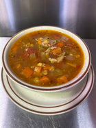 Image of a bowl of Chicken Vegetable Soup, containing chicken, corn, carrots, celery, tomato, bell pepper, onion, garlic, chicken stock, seasonings. Available in Berkeley.