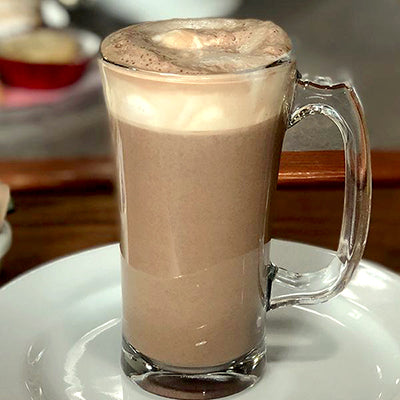 Hot Chocolate (steam milk, chocolate syrup, whipped cream). Available in Berkeley.
