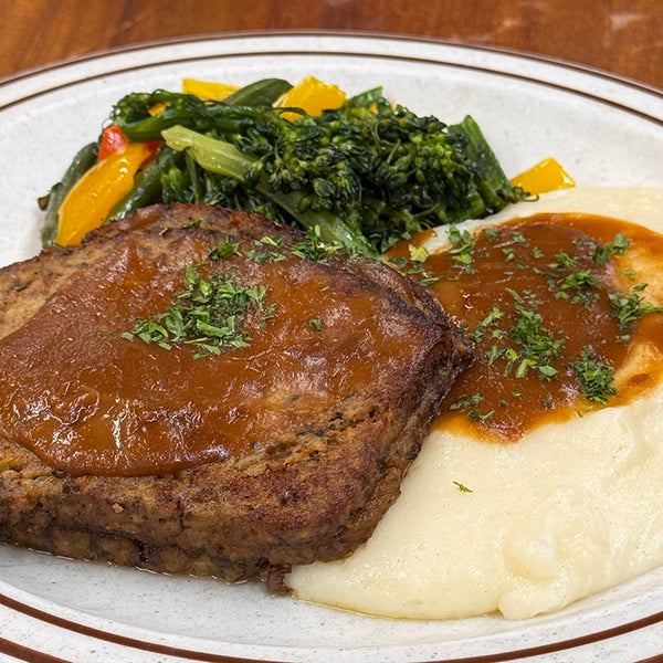 Sliced meatloaf, mashed potatoes and gravy, sauteed vegetable. Available in El Cerrito