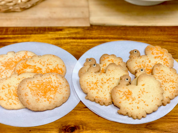 Sugar Cookies; one plate of pumpkin shaped and one plate of turkey shaped with orange sprinkles and eyes for the turkeys. Available in Berkeley.